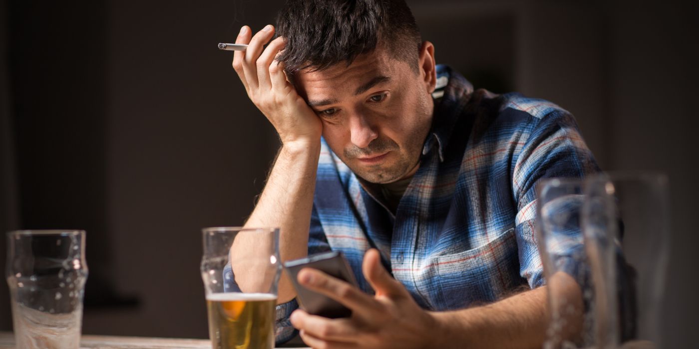 man on phone and drinking