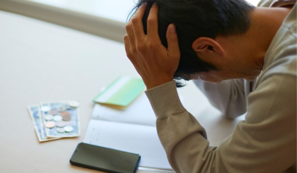 man stressing about finances - Lynk Diagnostics man stressing about finances