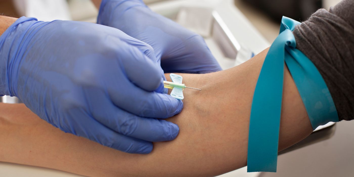 person drawing blood from arm