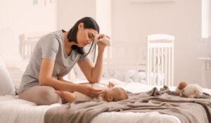 woman sitting on with baby