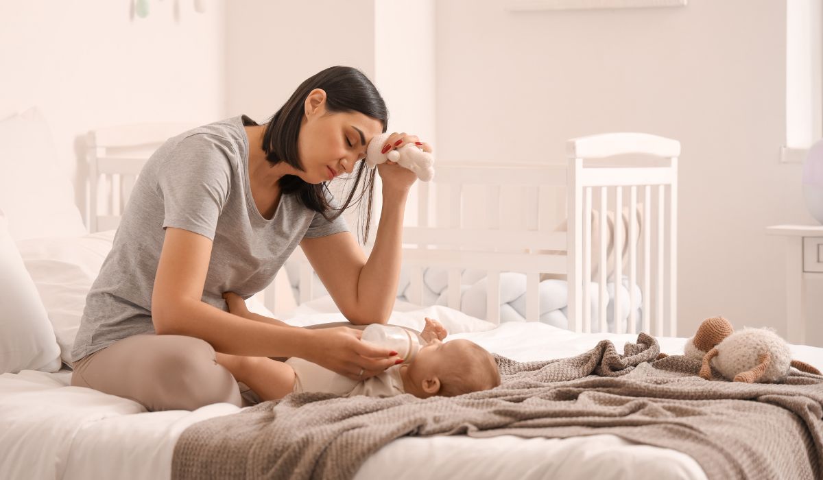 woman sitting on with baby