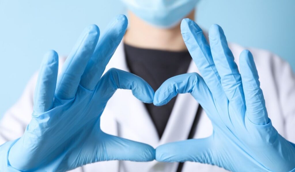 nurse forming heart with hands